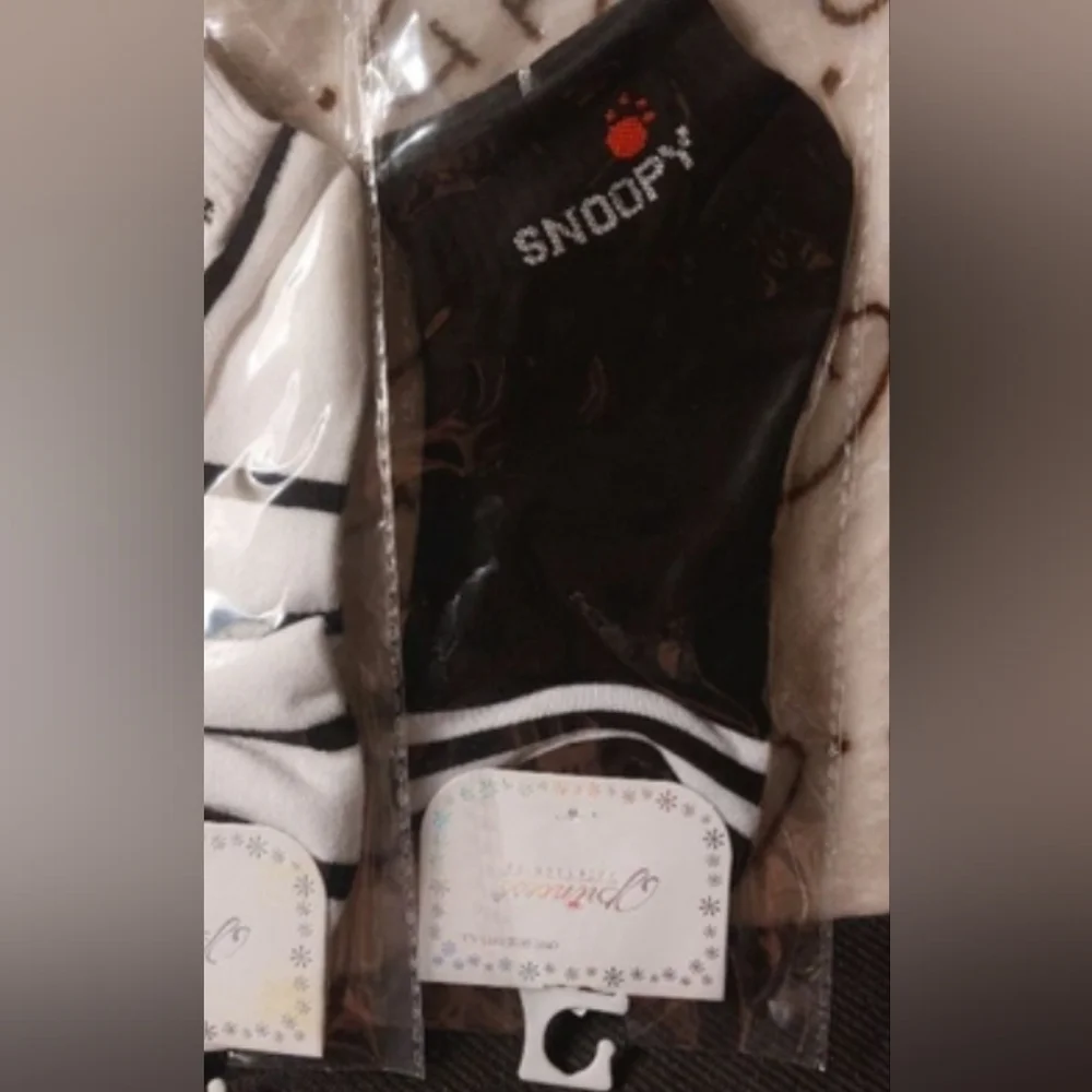 What is Snoopy up to? 2 black pairs & 1 white & stripe pair ankle socks.size 7-9